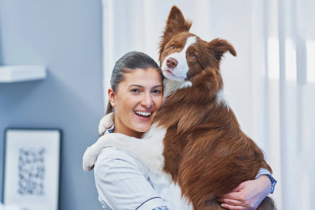 Frau umarmt liebevoll ihren Hund